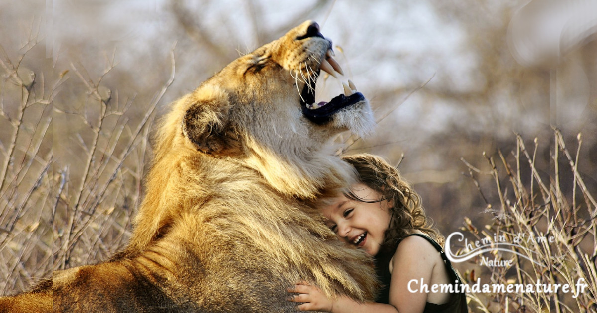 Une fille heureuse câline un lion
